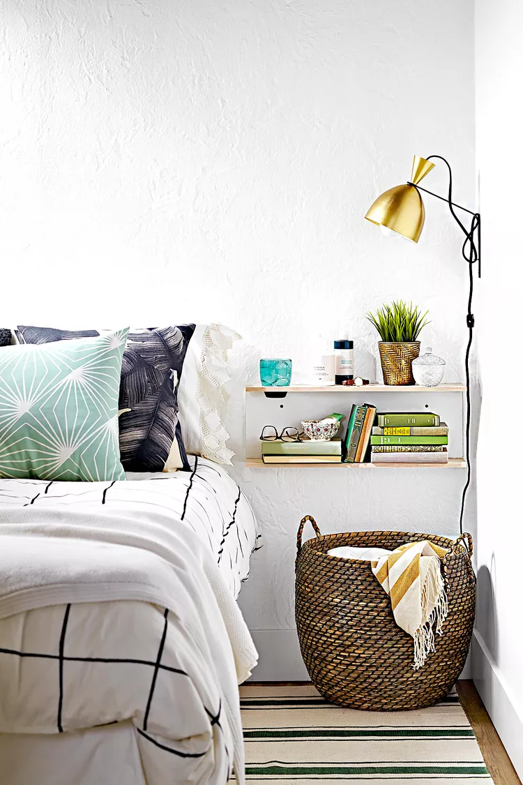 Small bedroom with floating shelves creating vertical storage on empty walls