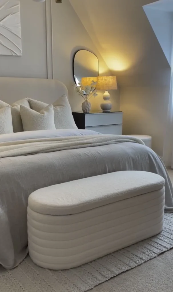 Storage bench at foot of bed replacing the clutter chair in a styled small bedroom