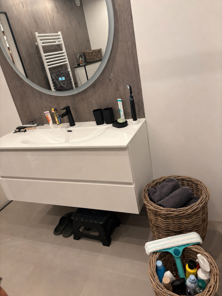 Woven planter baskets repurposed as small bathroom storage next to the vanity