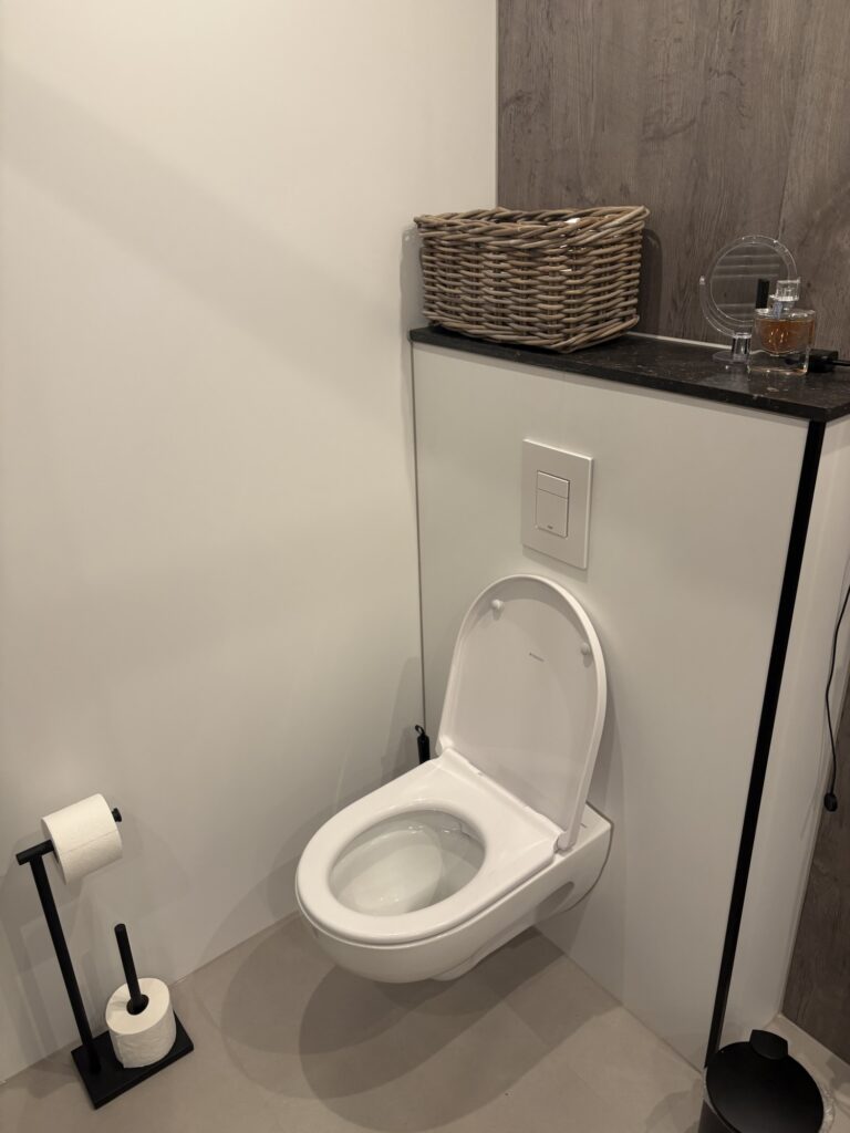 Woven basket on top of toilet cabinet holding bathroom essentials
