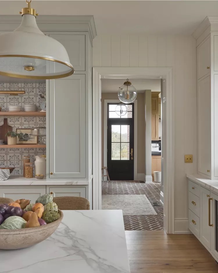 Frosted glass globe light fixture in a bright airy entryway