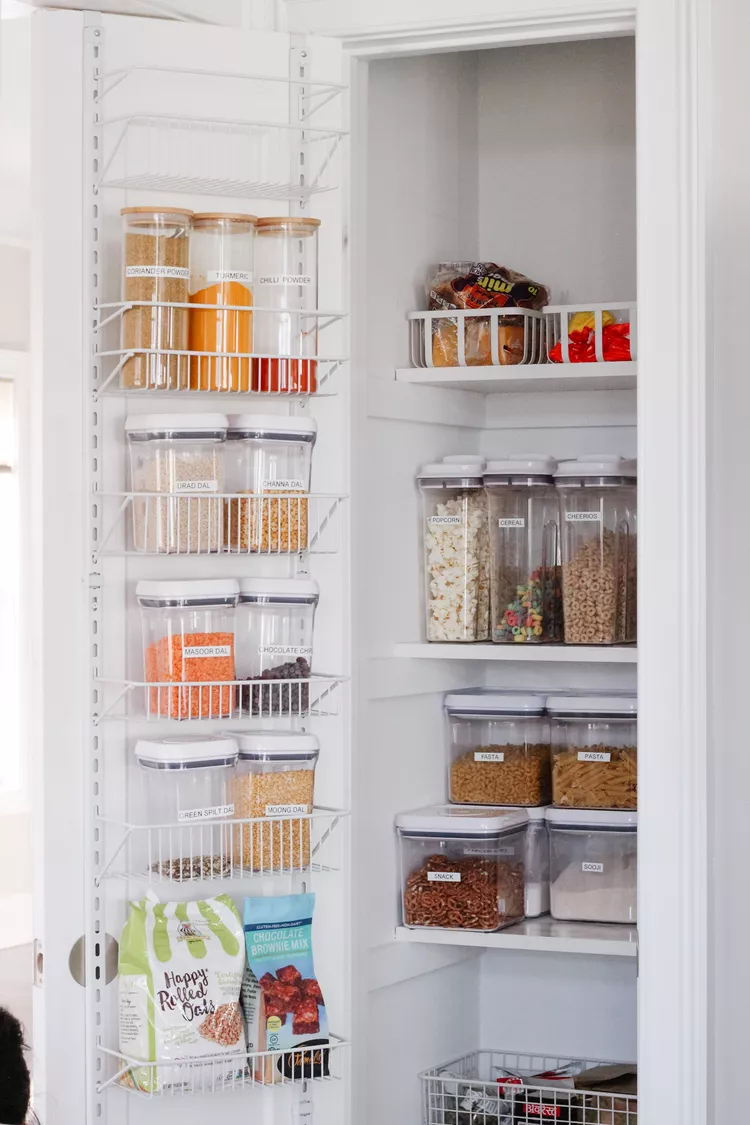 Over the door pantry organizer holding spices wraps and small packets