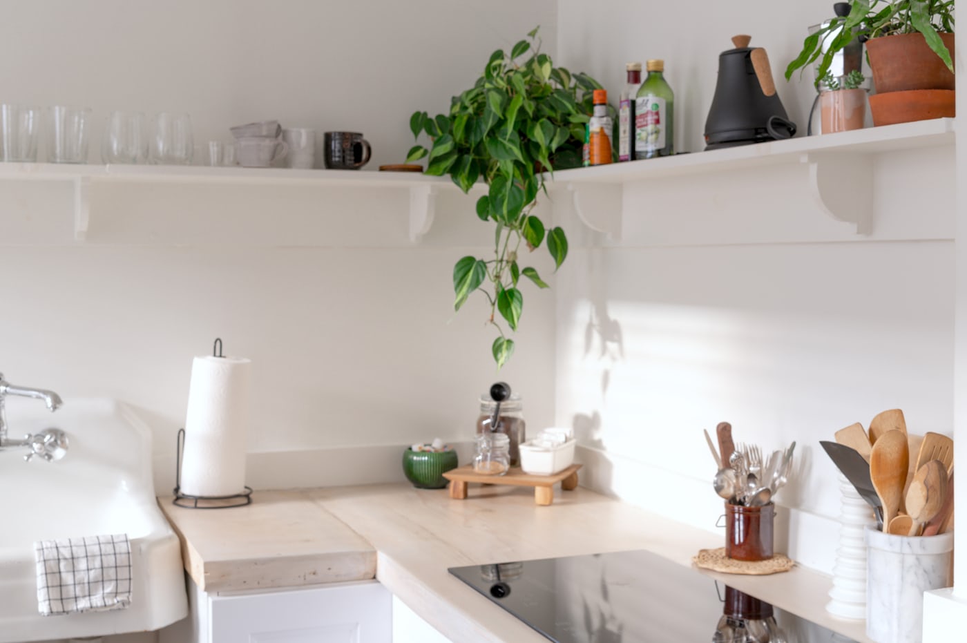 Small organized kitchen with clear counters and warm natural light