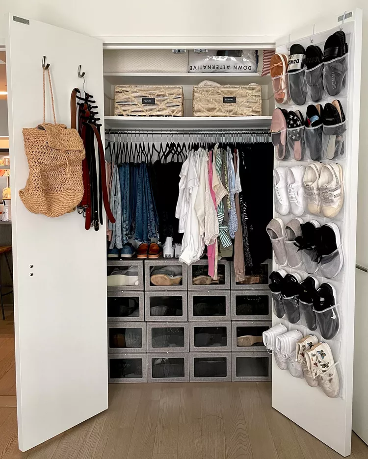 Organized closet with over the door shoe organizer and clear storage boxes