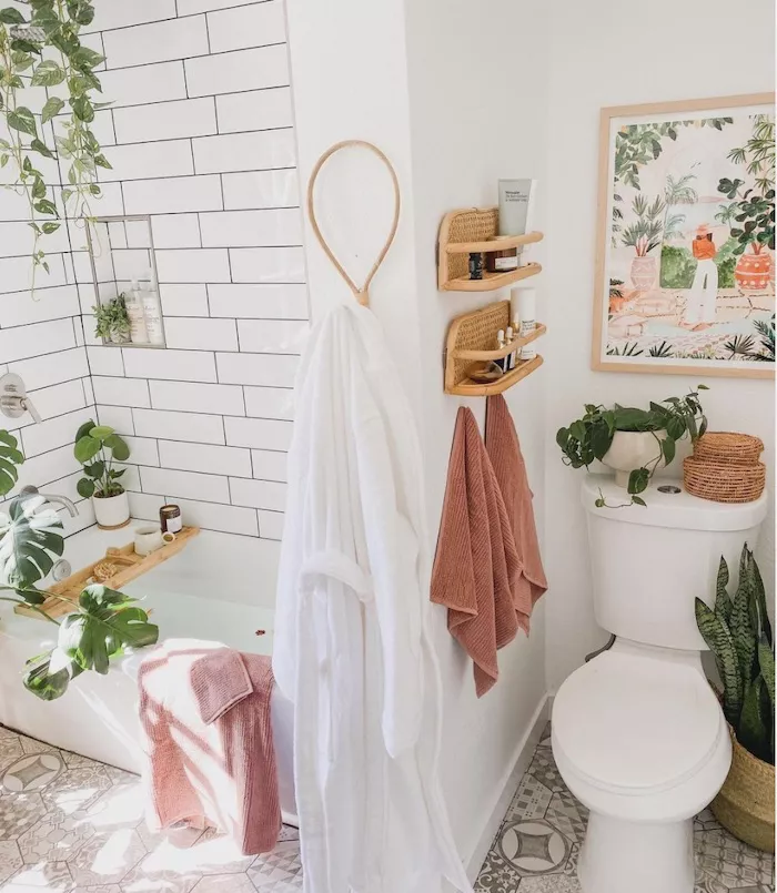 Bathroom with floating shelves styled with candles towels and minimal decor