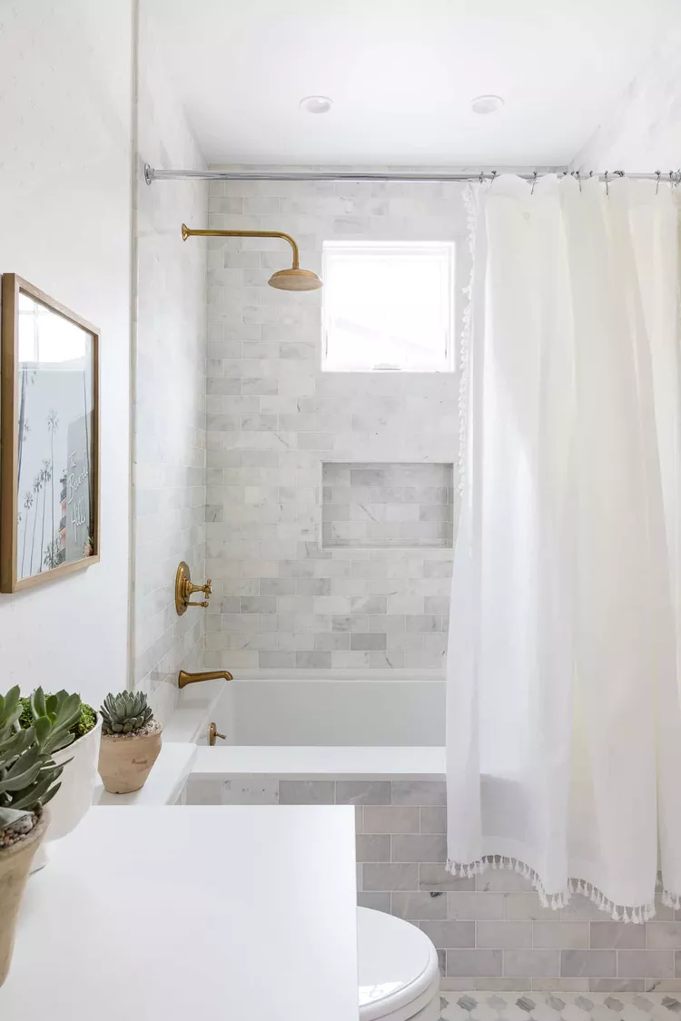 Clean minimal small bathroom with organized shelves and calm neutral tones