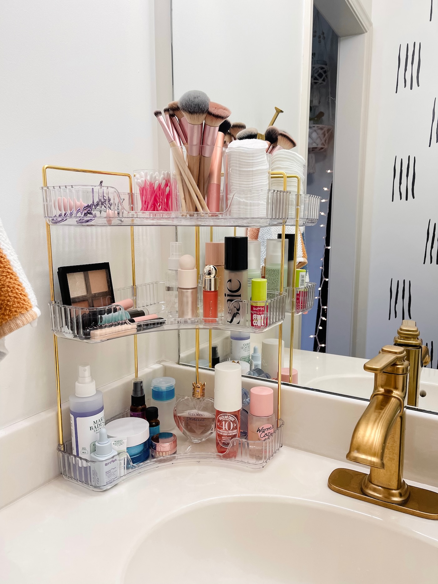 Small bathroom countertop with corner shelf organizer maximizing counter space