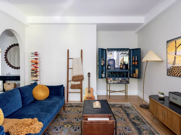 Small apartment living room with storage ottoman and cozy neutral styling