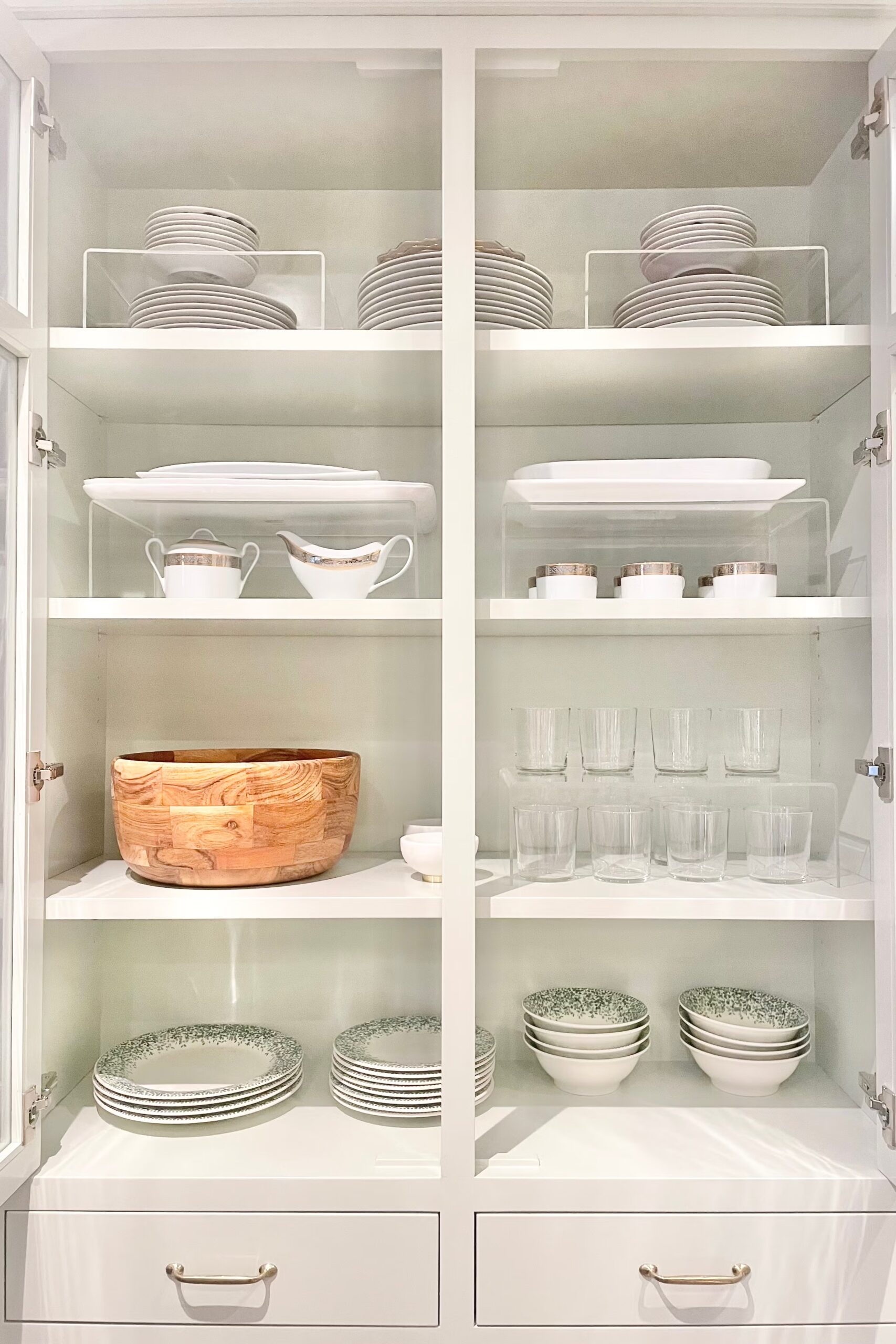 Pantry shelves with shelf risers creating two levels for cans and jars