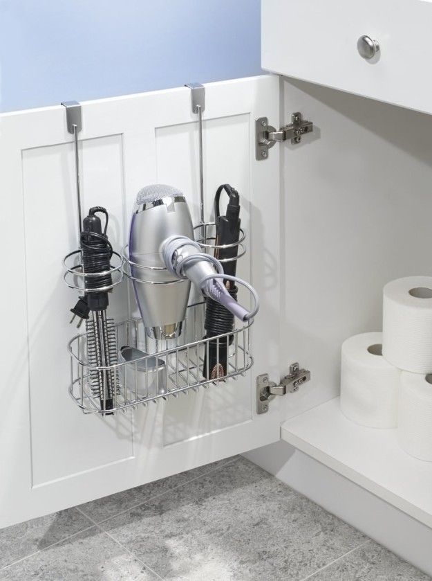 Over the door hair tool organizer holding hair dryer and styling tools in a small bathroom
