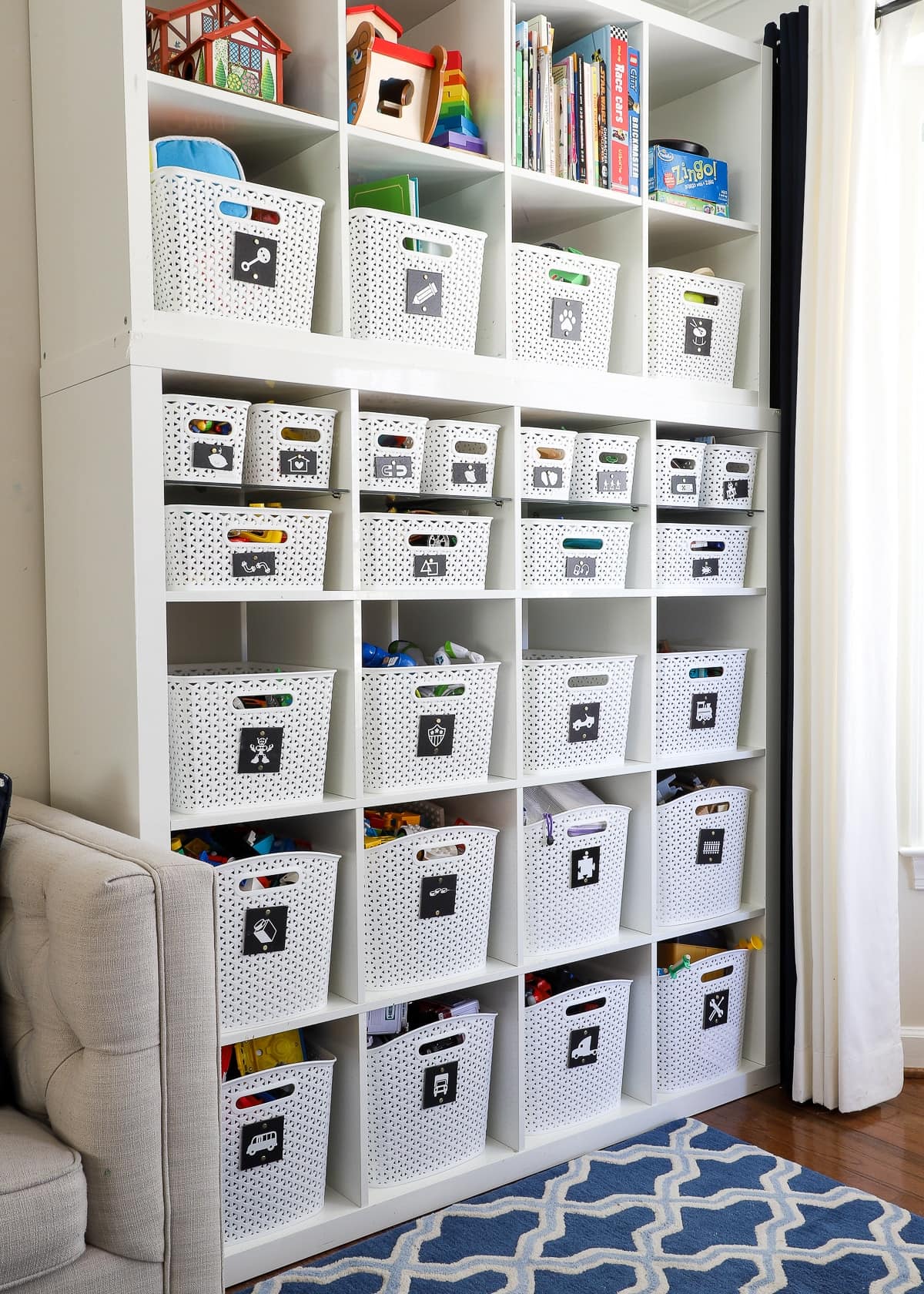 Cube storage organizer with labeled fabric bins for toy organization in a small playroom