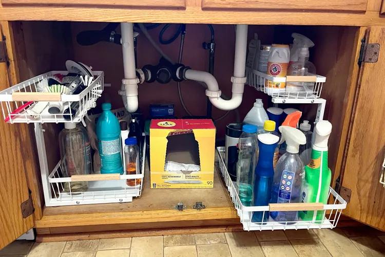 Under sink cabinet with cleaning caddy and organized products