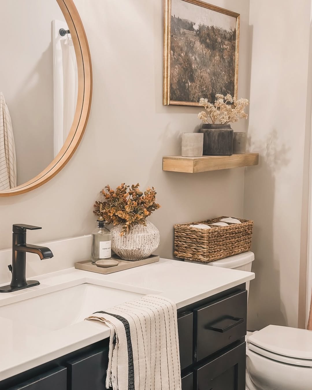 Styled bathroom counter with vanity tray matching dispensers and organized products