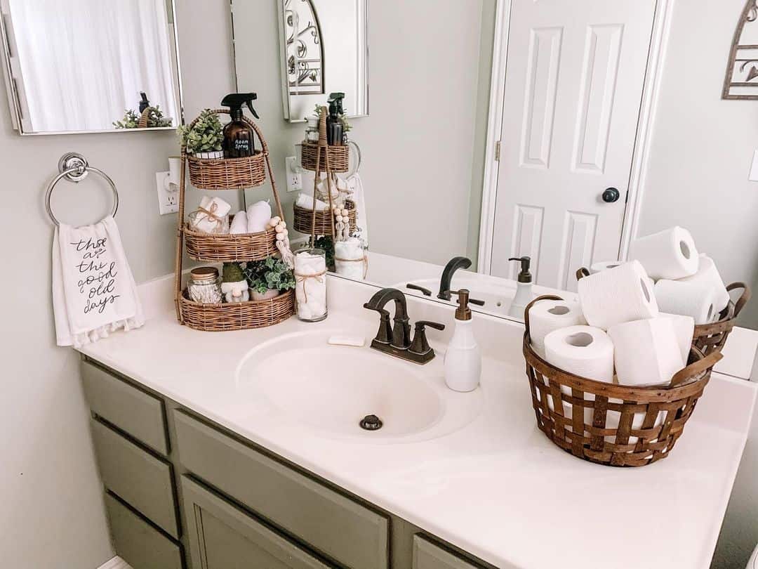 Small bathroom counter with woven basket and apothecary jars neatly organized