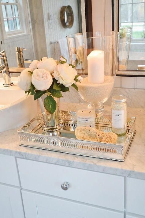Bathroom counter with faux plant candle and mirrored tray creating a spa like atmosphere