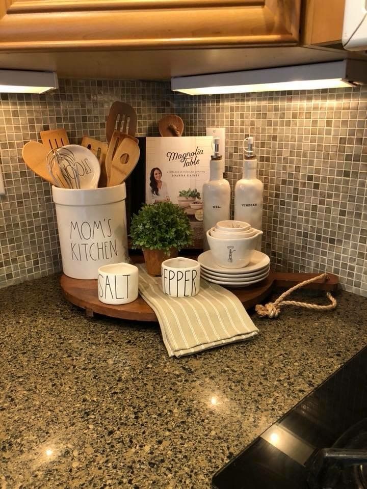 Styled kitchen counter with wood lazy susan holding oils and daily essentials