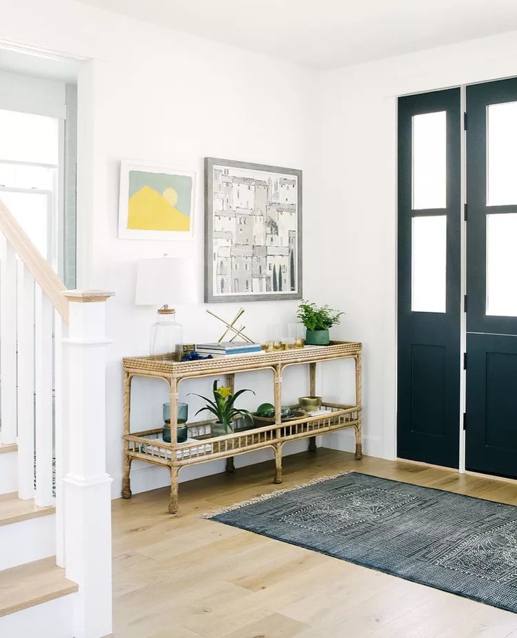 Small faux plant on entryway table adding greenery and life to a neutral styled entrance