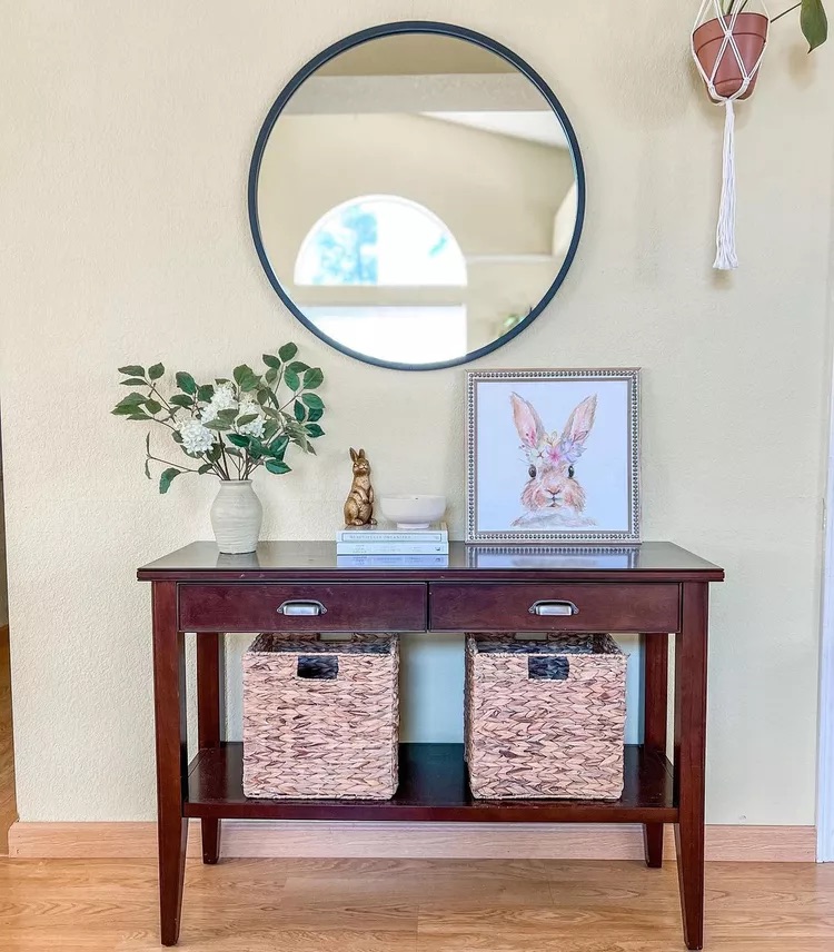 Entryway console table with woven basket on lower shelf for hidden storage