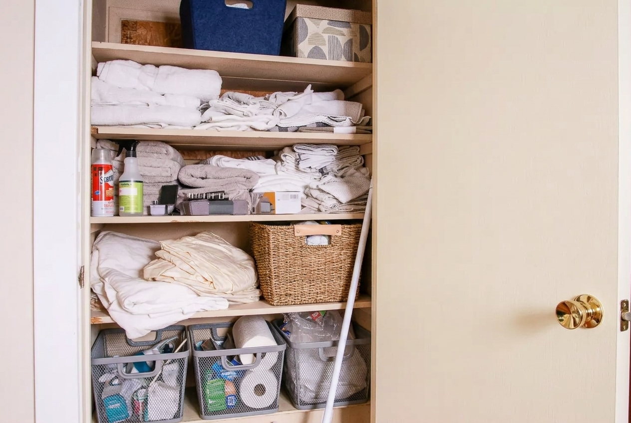 A cluttered small closet before a reset